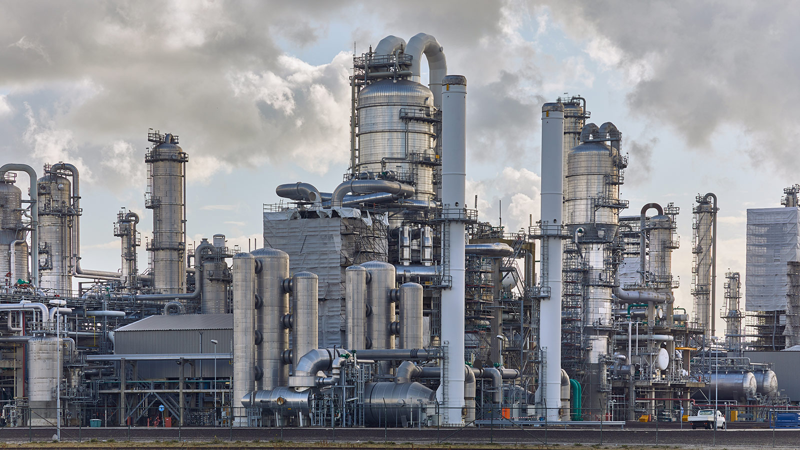 Industrial chemical processing facility with process towers, stainless steel piping, and equipment designed for handling corrosive chemicals. Industrial chemical processing facility with process towers, stainless steel piping, and equipment designed for handling corrosive chemicals.