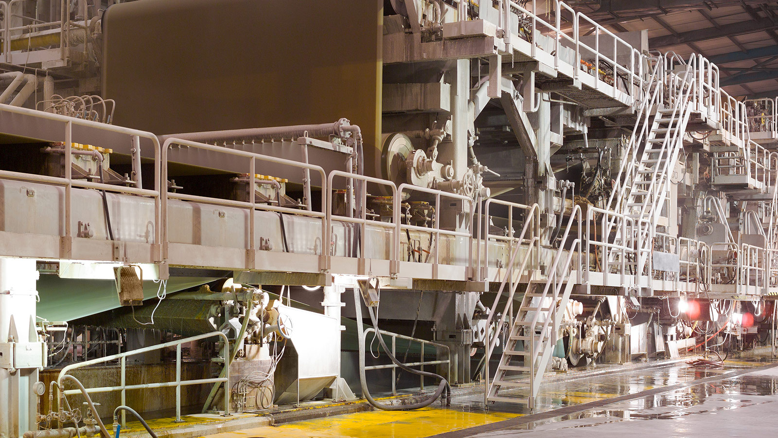 Pulp and paper mill with industrial paper production equipment and process systems for continuous manufacturing. Pulp and paper mill with industrial paper production equipment and process systems for continuous manufacturing.